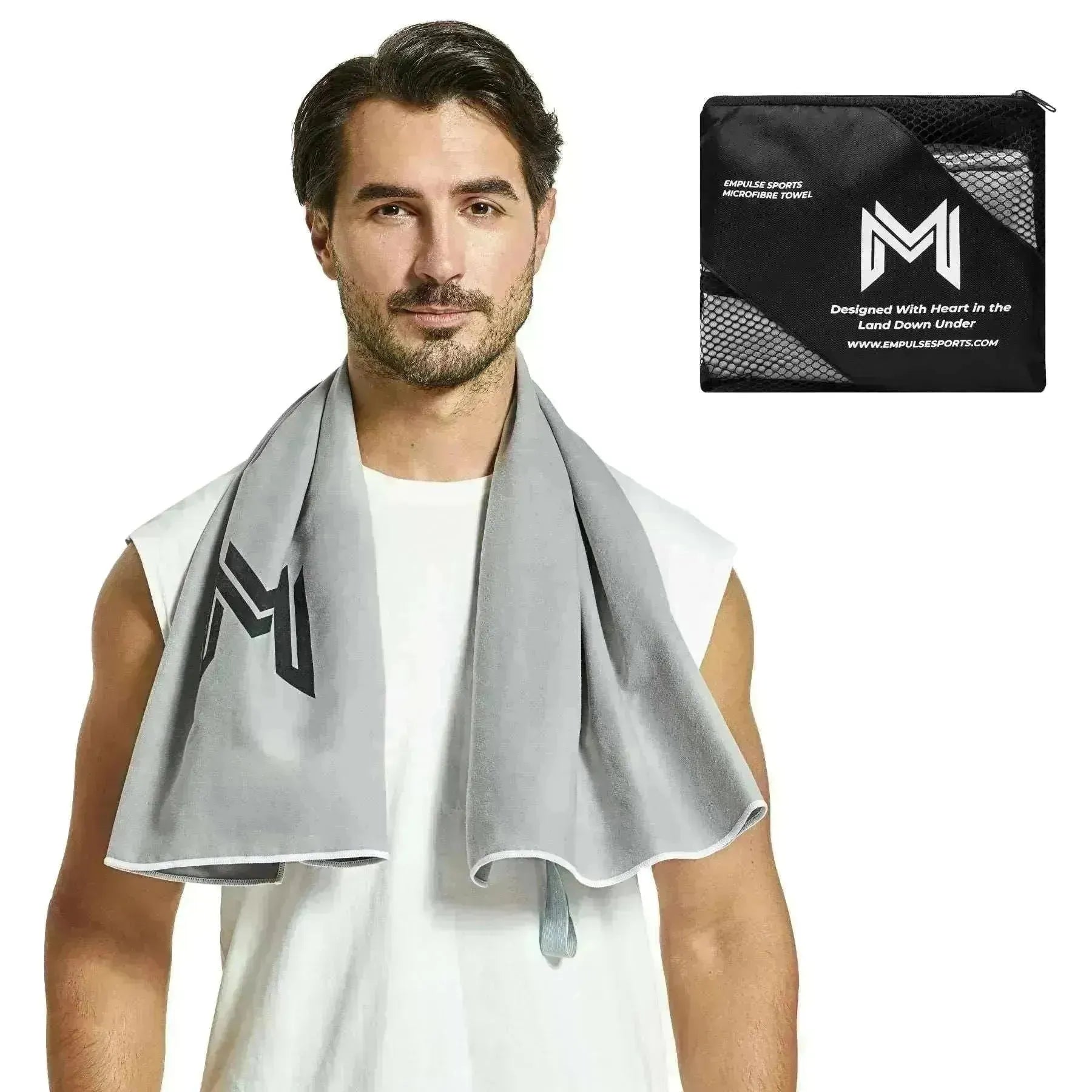 Studio shot of model with Empulse™ Carbon Cool towel featuring bold “M” logo