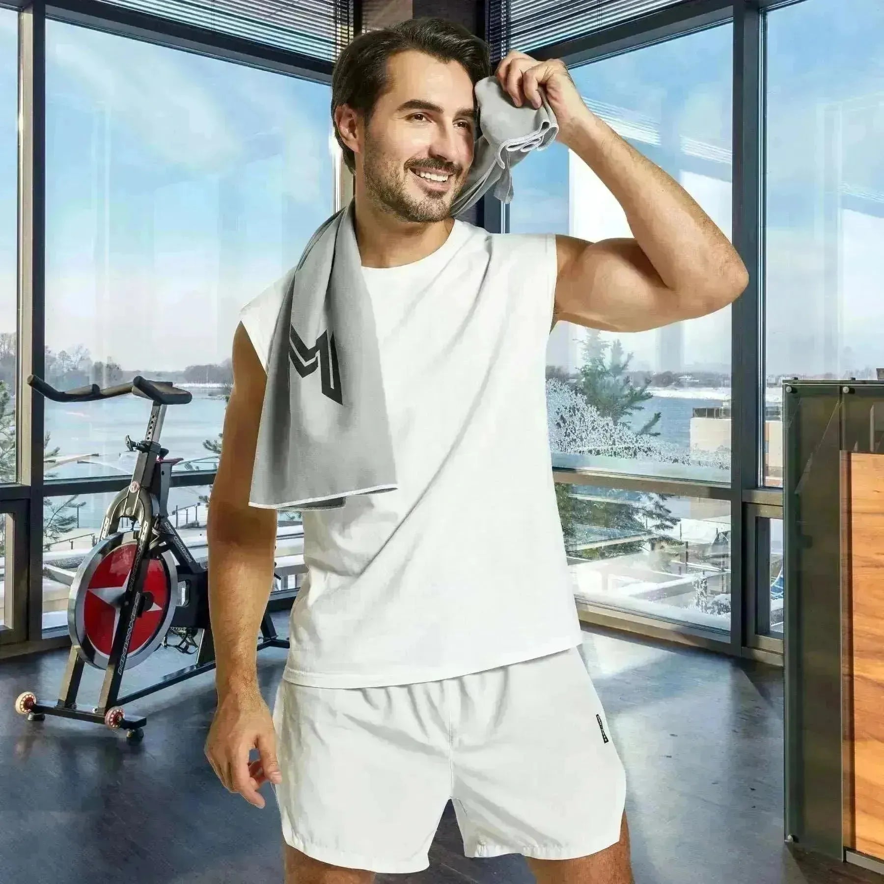 Empulse™ Carbon Cool towel used by model to wipe face after intense workout