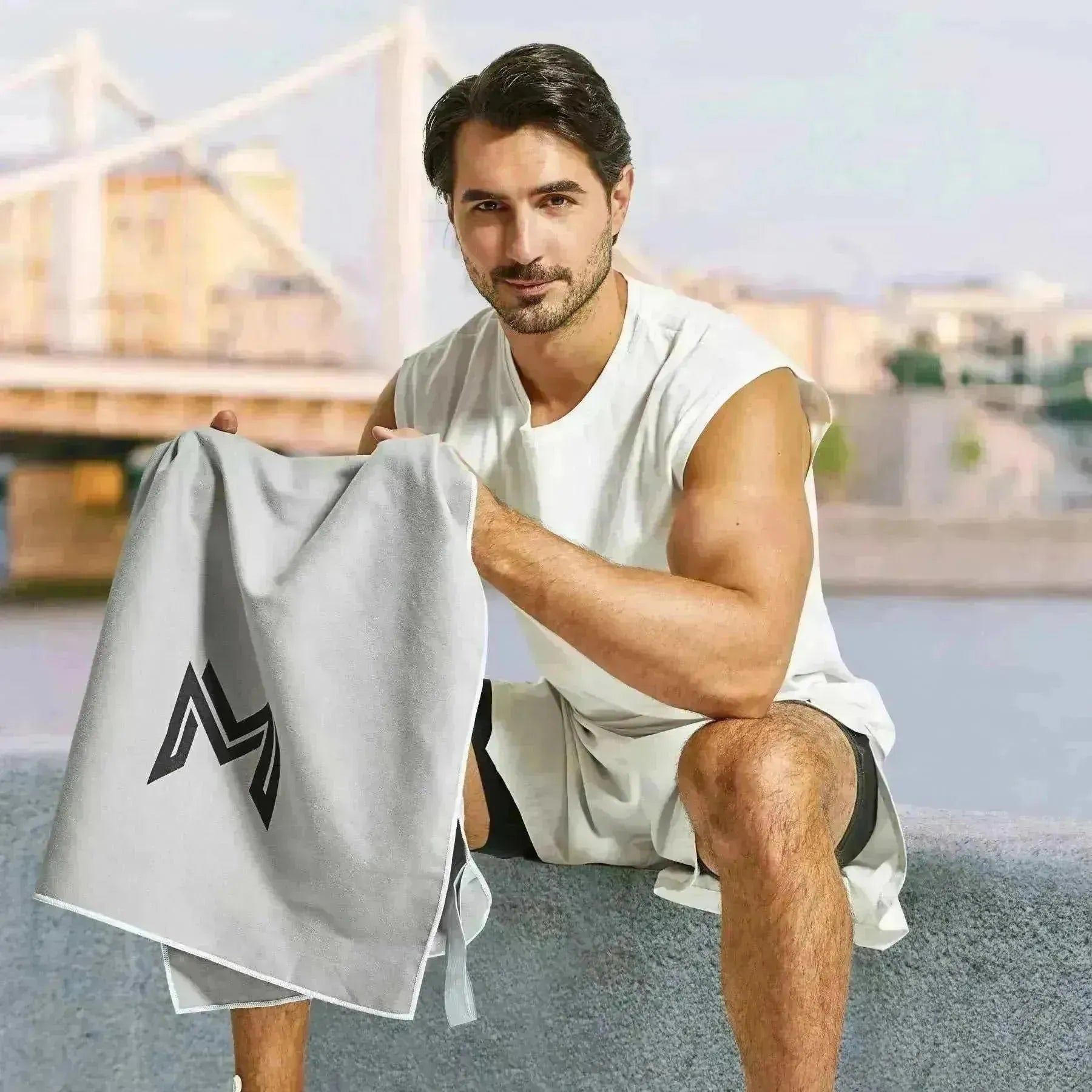 Model seated with Empulse™ Carbon Cool towel after training on rooftop gym