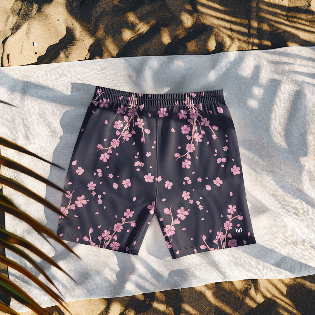 Flat lay of Empulse™ Cherry Blossom shorts on pool chair with palm tree shadows