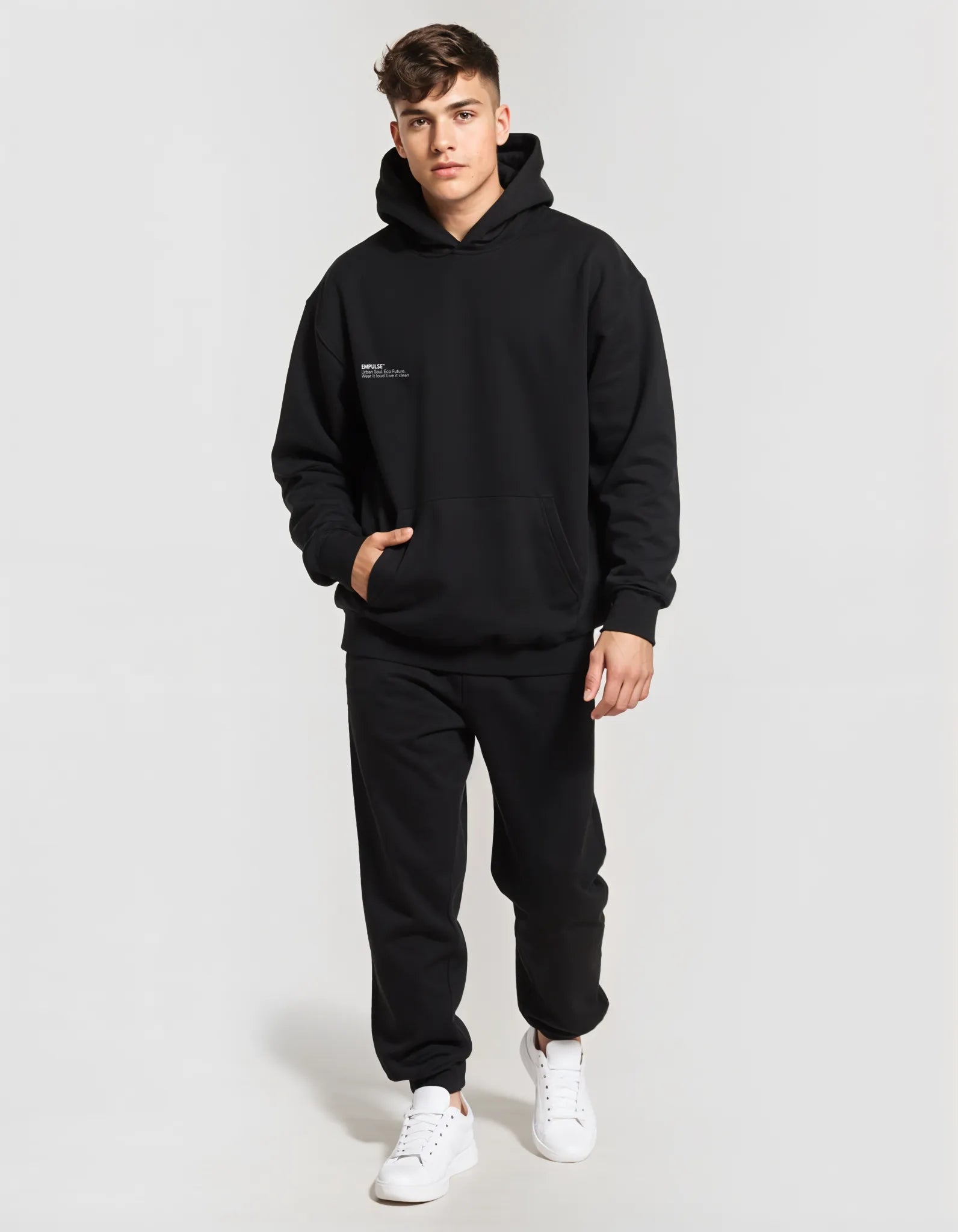 Full-body view of male model wearing black Empulse DNA Hoodie with hands in pocket

