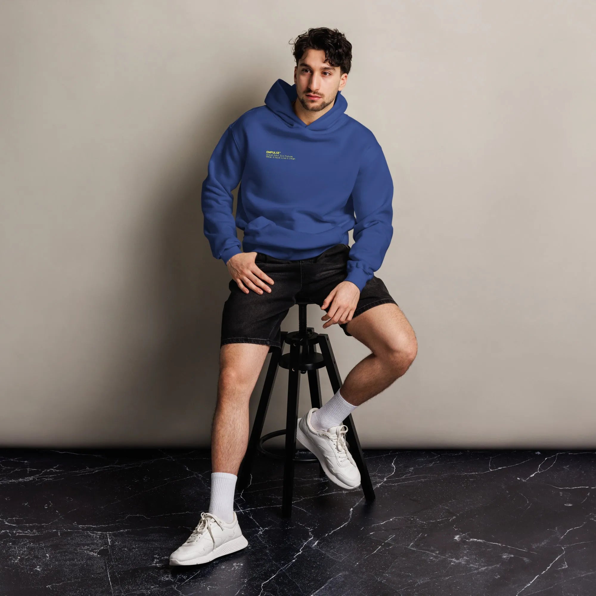  Empulse DNA Hoodie in Deep Blue with neon print worn by seated male model