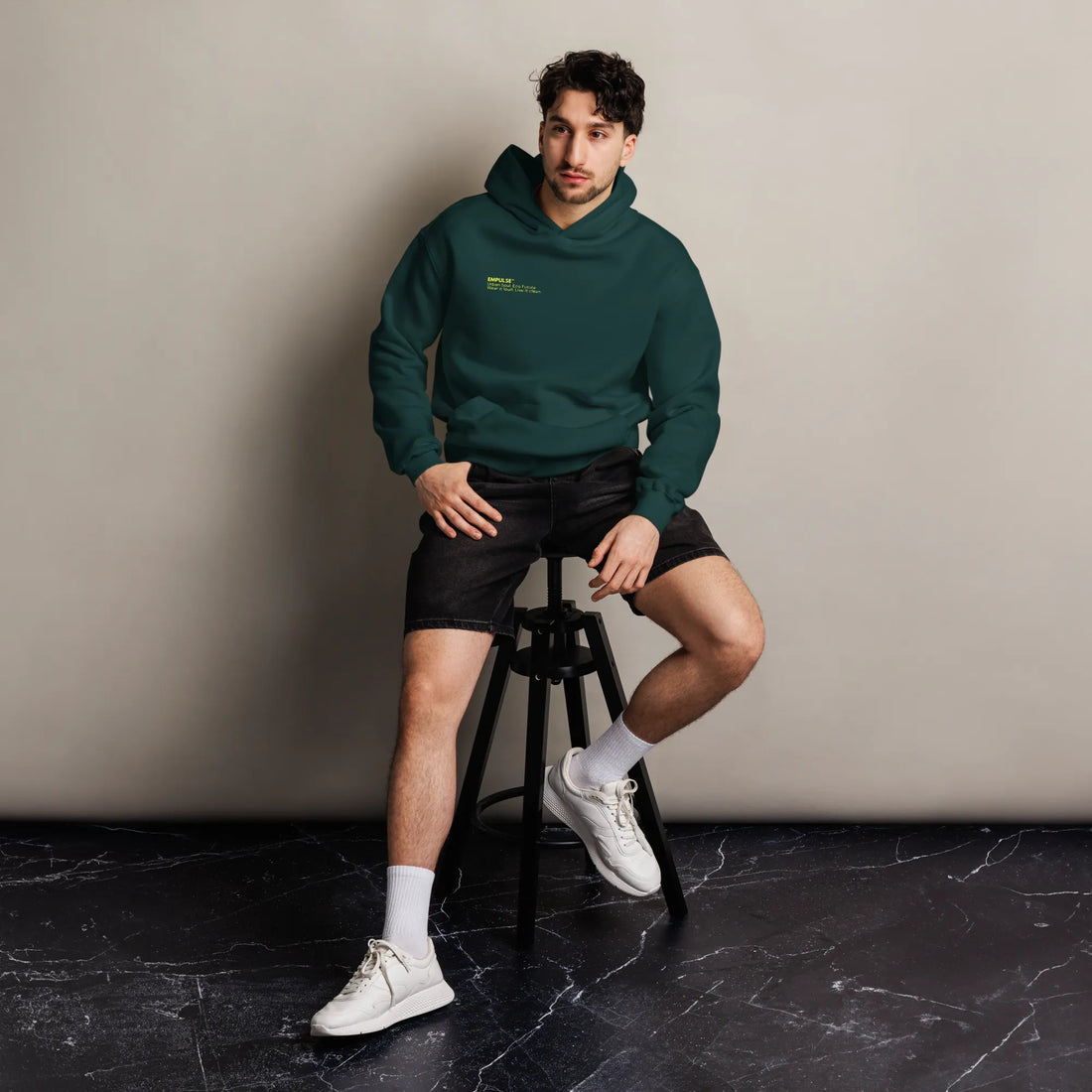 Male and female model both wearing forest green Empulse DNA Oversized Hoodies

