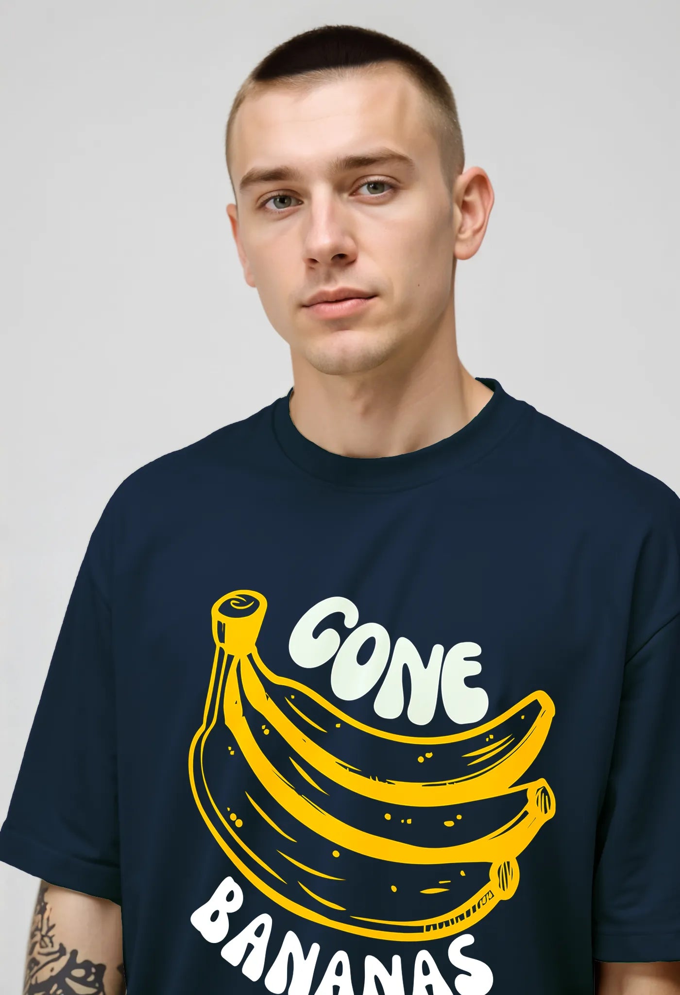 Empulse™ Gone Bananas t-shirt in navy Sorona blend with bright yellow banana graphic, worn by male model close-up