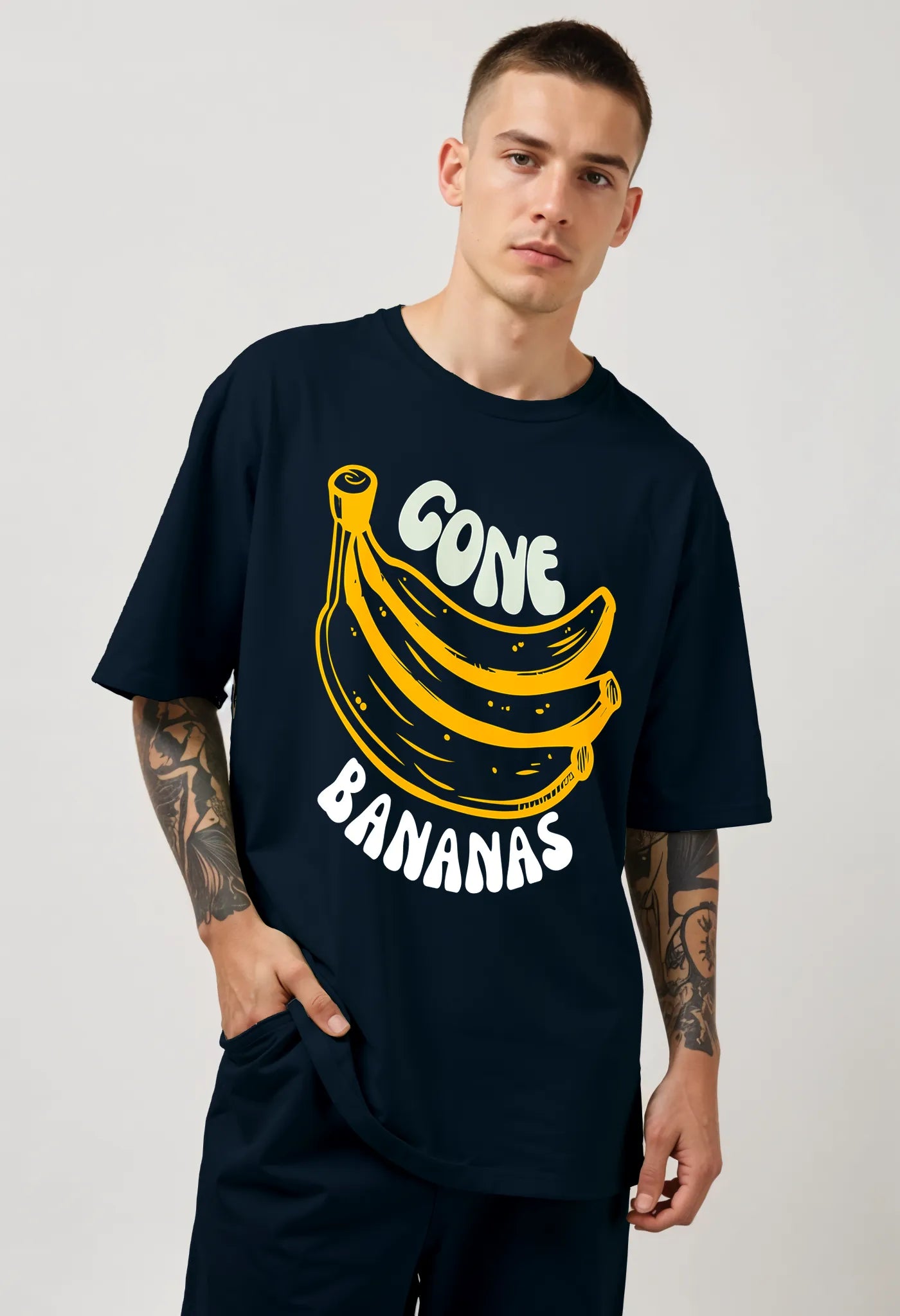 Front view of Empulse™ navy banana tee styled with relaxed fit and bold print, worn by standing model