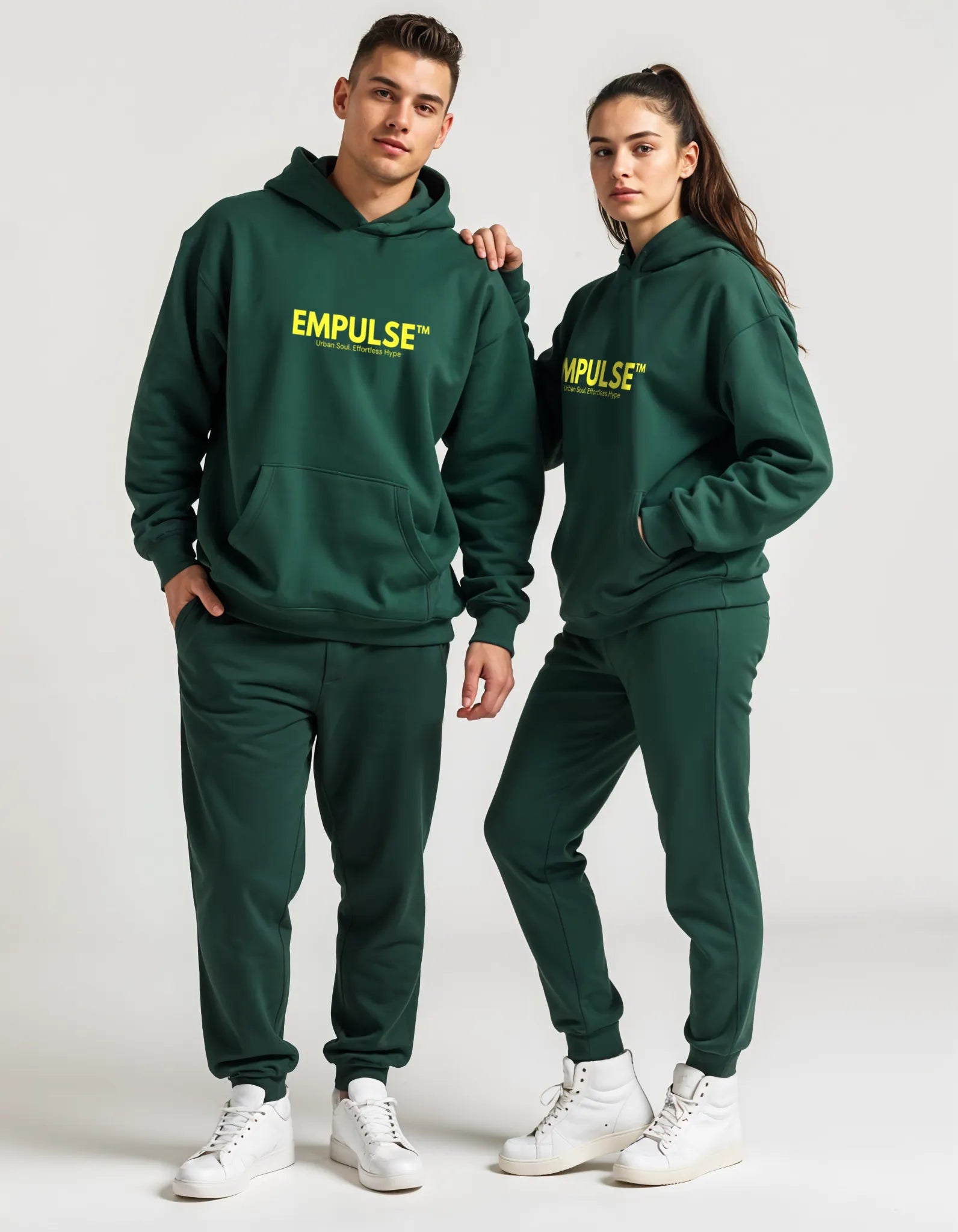 Male and female models in matching Empulse™ green hoodies and pants, coordinated unisex look