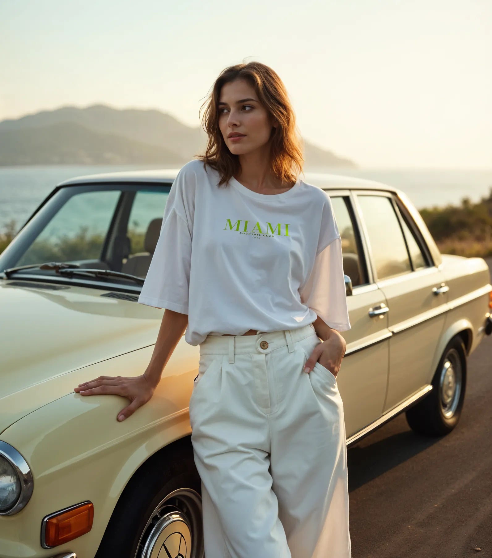 Empulse™ Sorona tee in white worn casually during golden hour, showcasing Miami drinks back design
