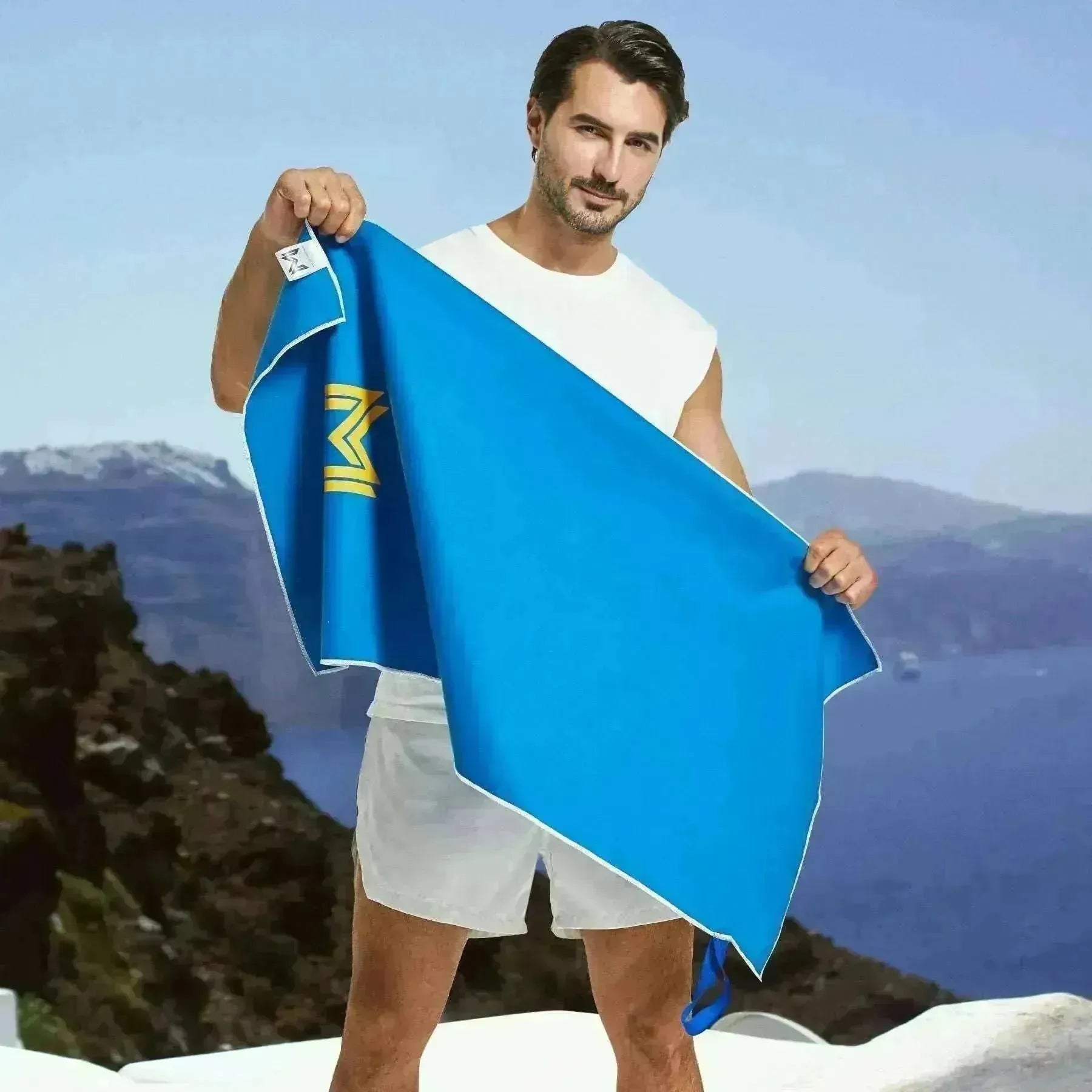 Model holding full-size Empulse™ Midnight Burn towel outside under clear sky