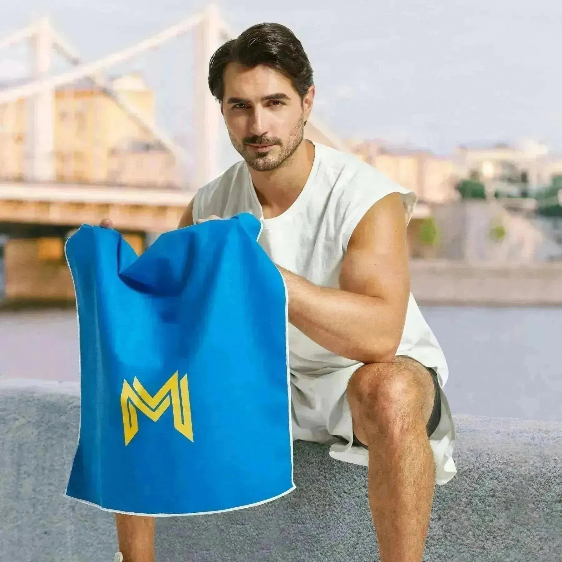 Empulse™ Midnight Burn gym towel worn while resting after training, city skyline behind