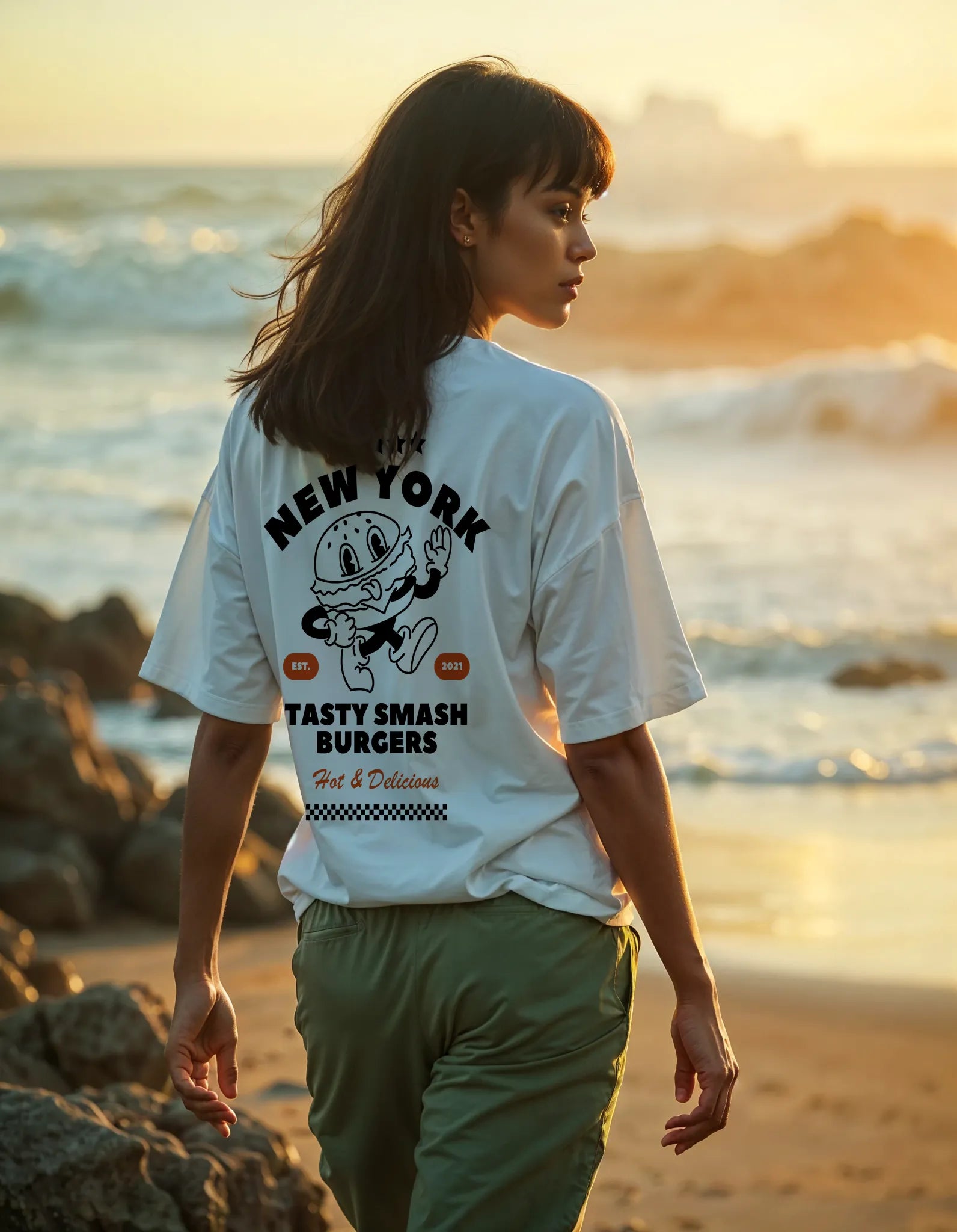 Empulse™ New York Sorona tee styled at golden hour with burger badge and back graphic