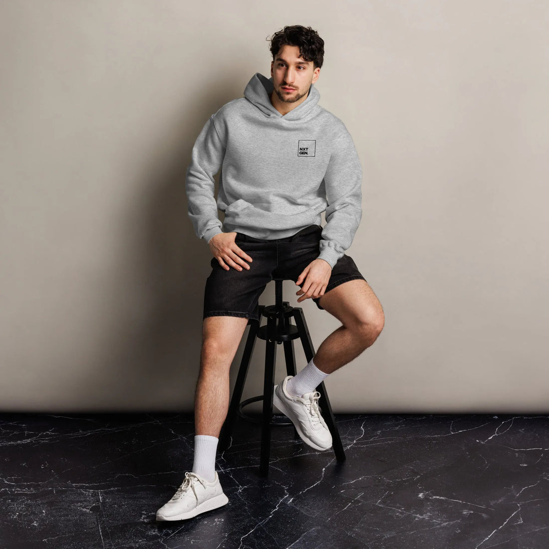 Empulse™ oversized grey hoodie worn by male model sitting front-facing