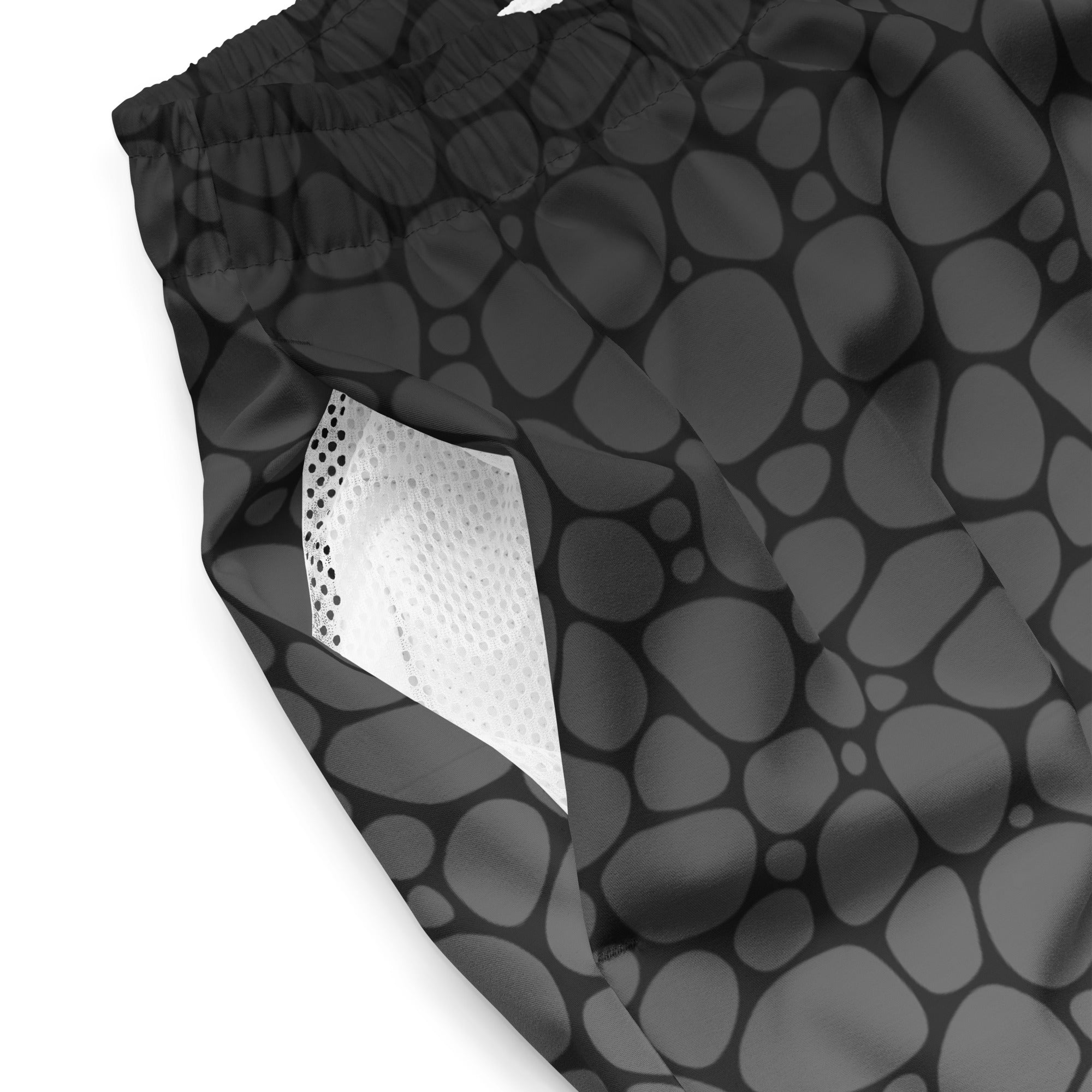Close-up of Empulse™ Pebbles fabric showing black-and-grey pebble pattern and white mesh lining