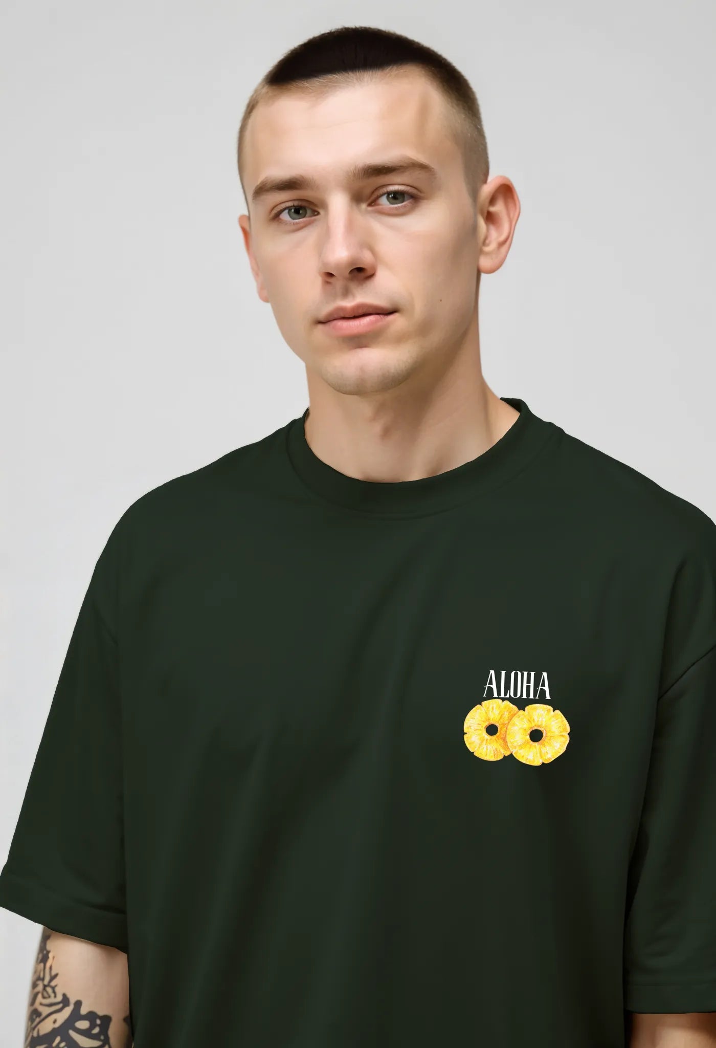Empulse™ Sorona pineapple tee in green showing subtle yellow fruit chest logo on front