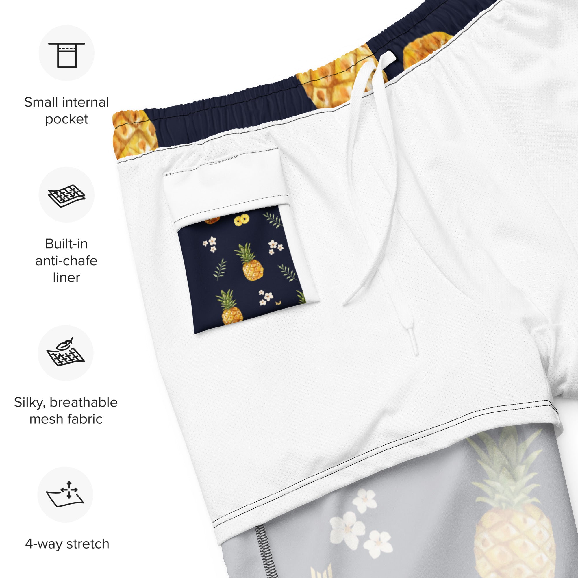 Fabric close-up of Empulse™ Pineapple Paradise shorts showing pineapple and leaf design