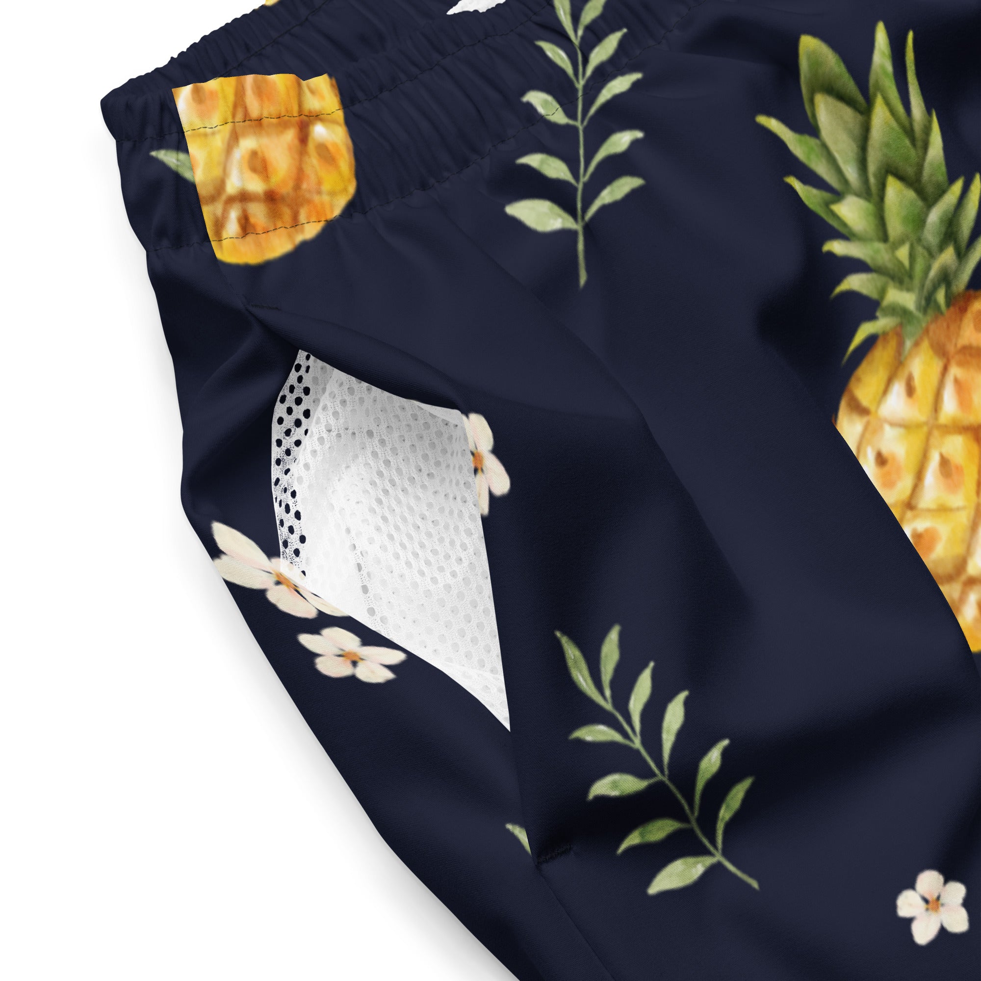 Flat lay of Empulse™ Pineapple Paradise shorts showing inner label and sizing chart