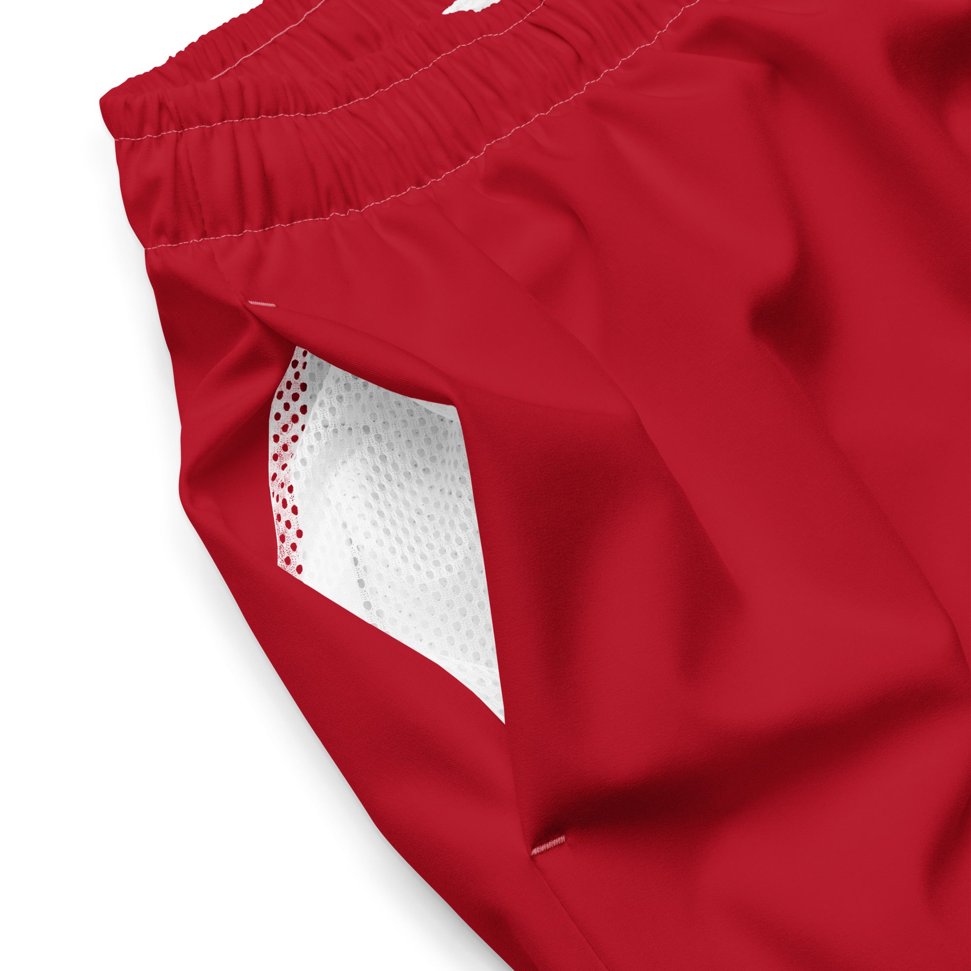 Close-up of Empulse™ Red shorts fabric showing white mesh pocket and vibrant color