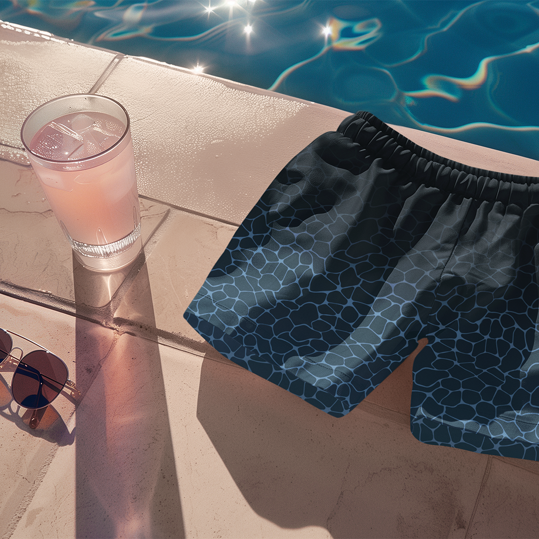  Flat lay of Empulse™ Ripple Magic swim shorts on pink poolside towel