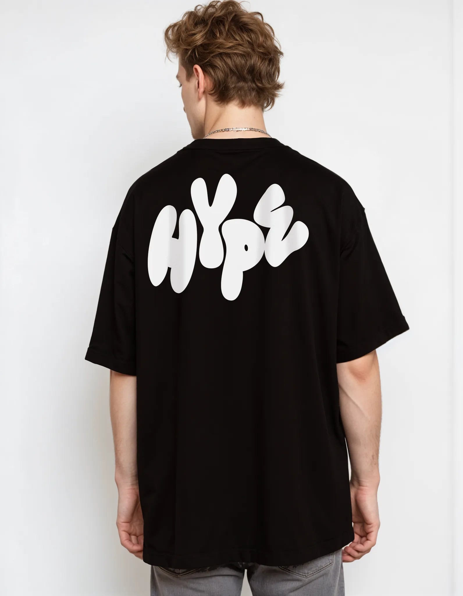 Back view of Empulse™ black Sorona tee featuring large stylized EMPULSE text across shoulders