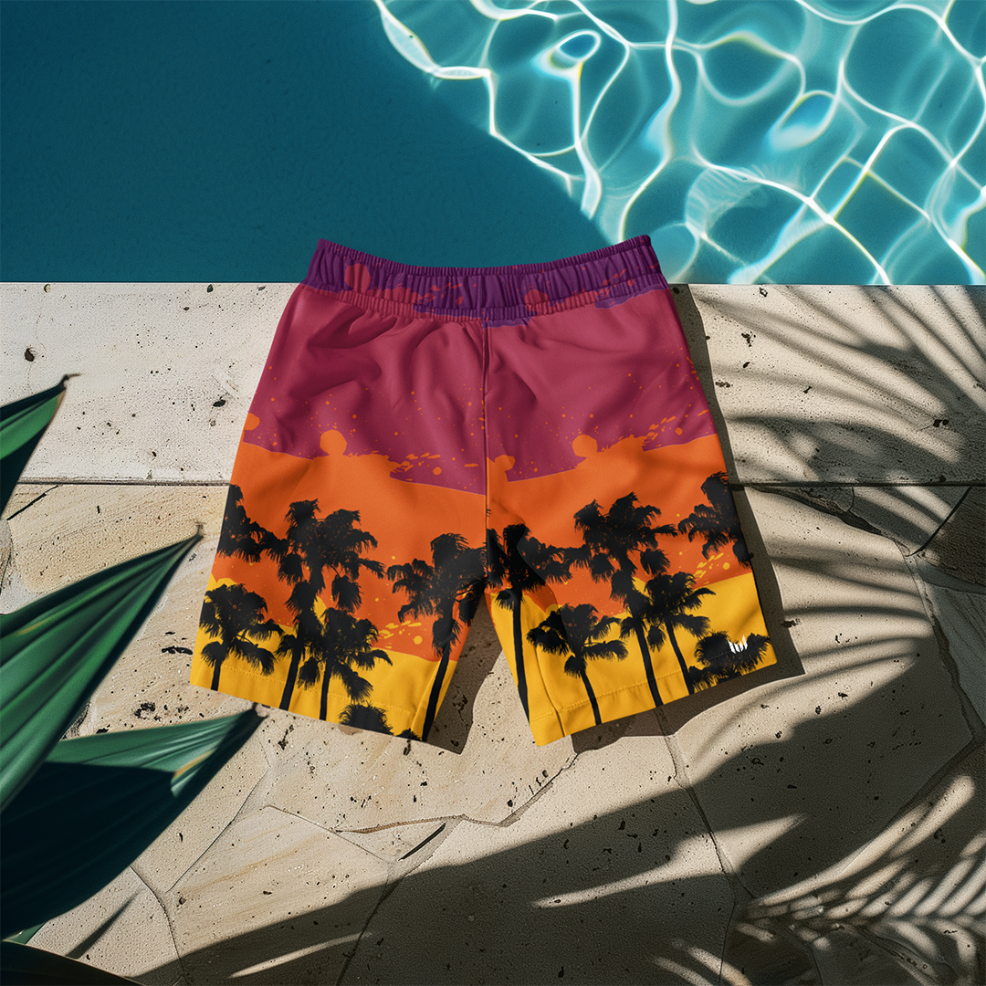 Flat lay of Empulse™ Tropical swim shorts laid out on white poolside lounge chair