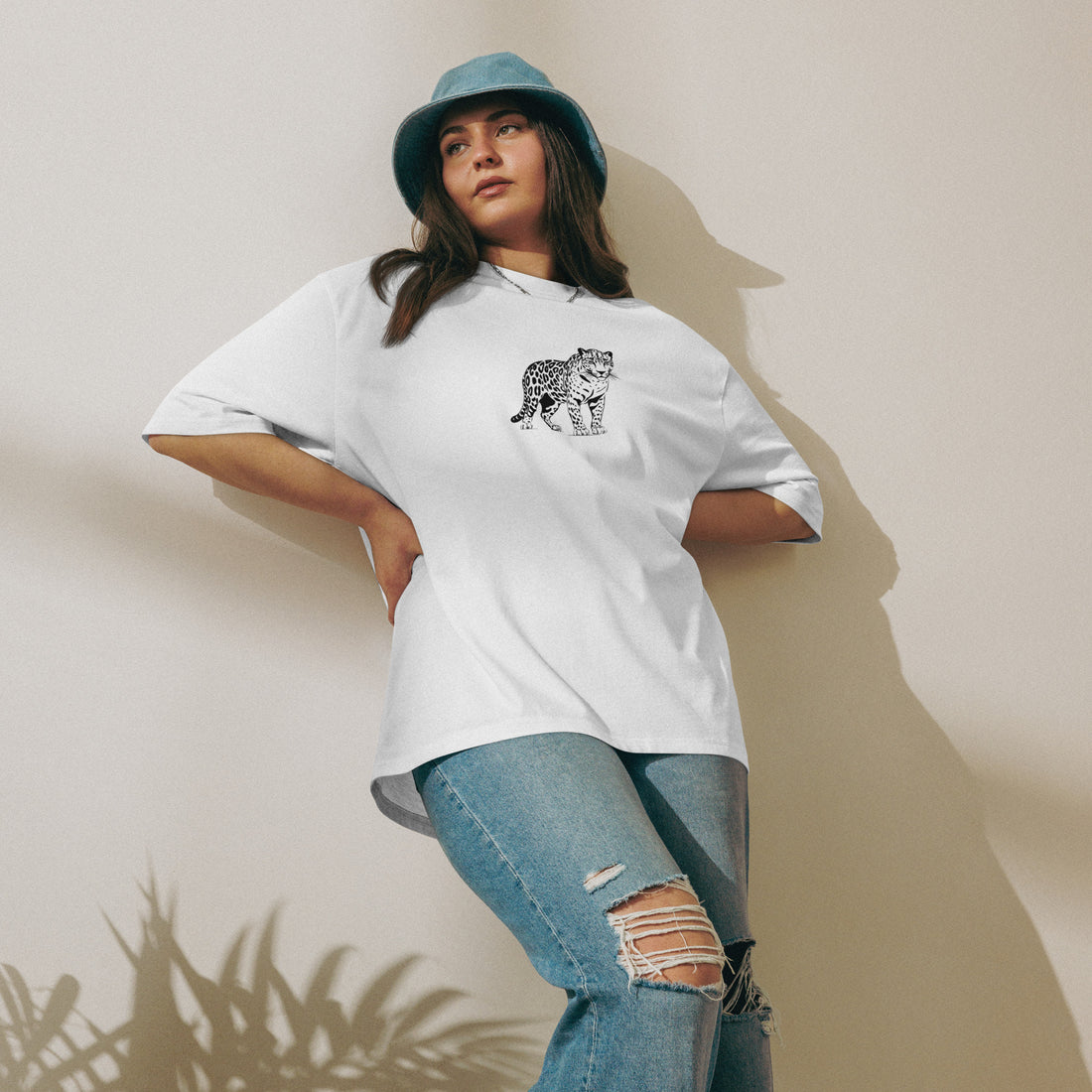 Female model posing in oversized Empulse® Urban Streets Leopard Tee