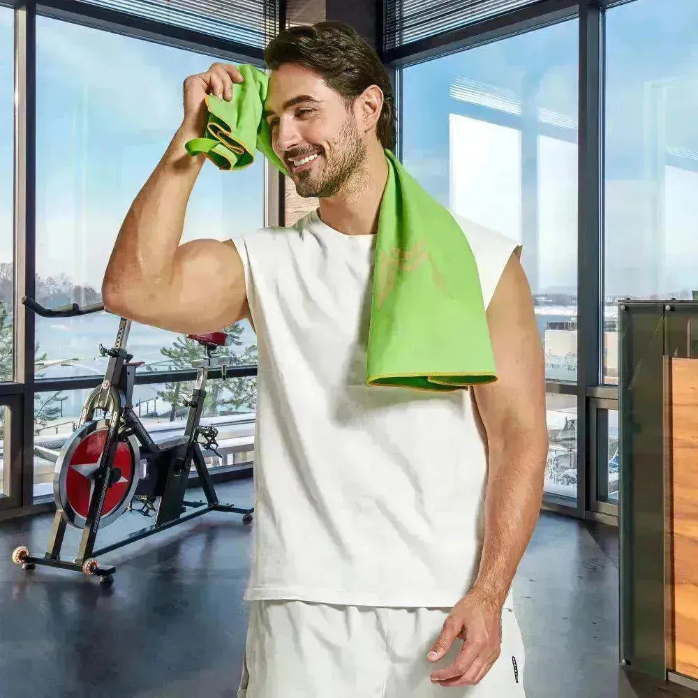 Model using Empulse™ Zen Lift towel to wipe sweat during training session