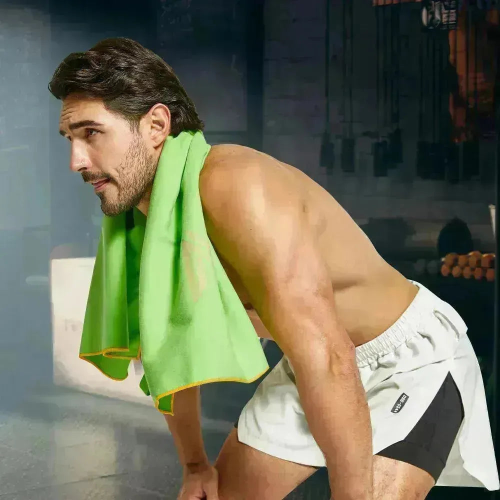 Empulse™ Zen Lift gym towel draped over shoulders during workout in low-lit gym