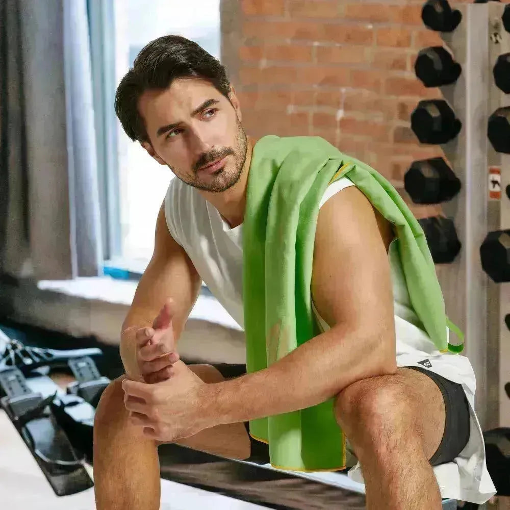 Empulse™ Zen Lift towel worn during indoor dumbbell training in modern gym