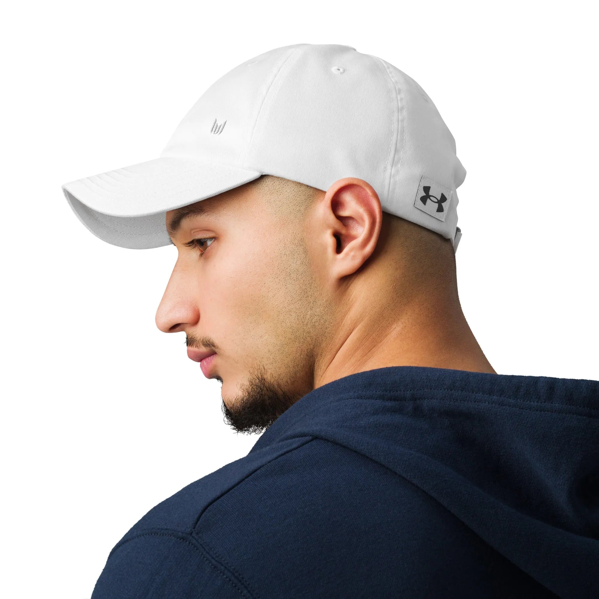 White Under Armour dad hat modeled with navy hoodie, side profile