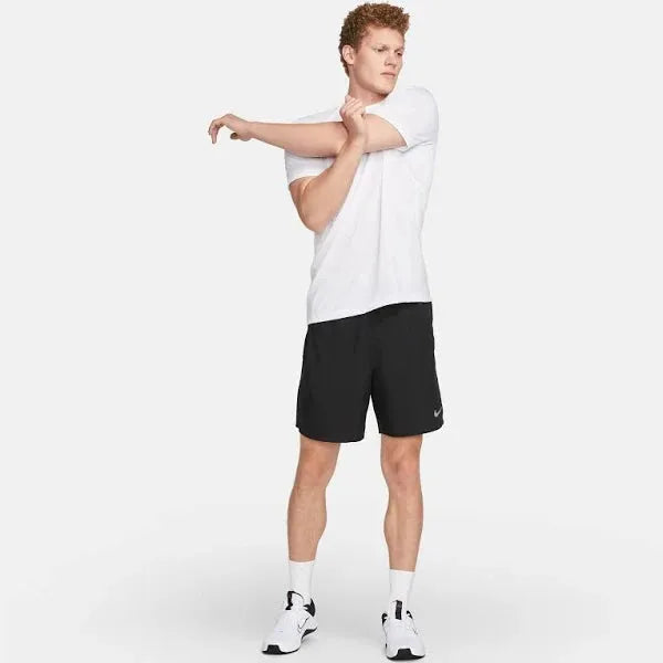 Nike Pocketed Dri-FIT Shorts – male model stretching in full outfit view.