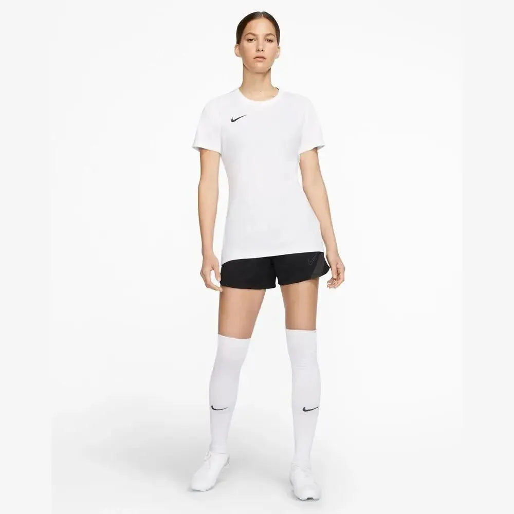 Full-body view of model wearing Nike Women's Park 7 Jersey in white with black shorts and white Nike Socks