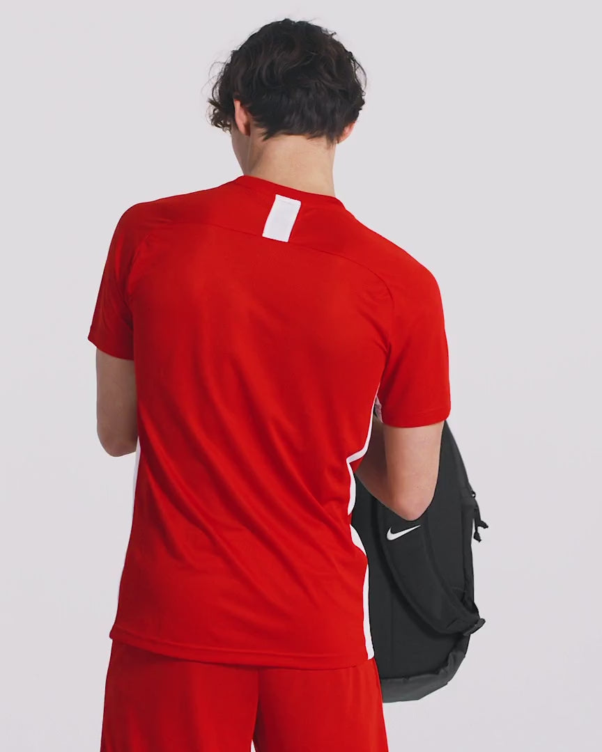 Athlete in red kit wearing Nike Academy Team Backpack 30L in black

