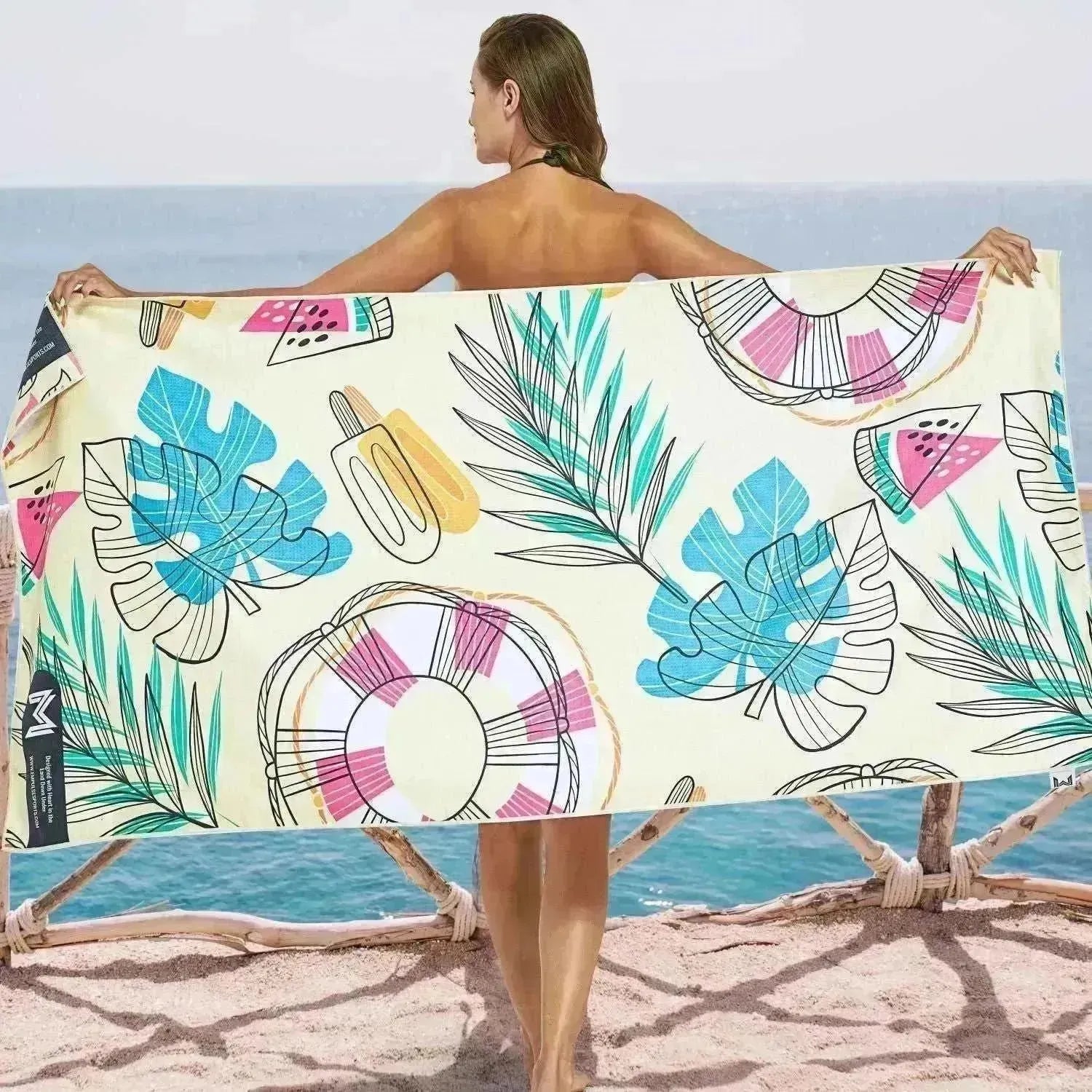 Empulse Summer Fun towel spread on sand near shoreline