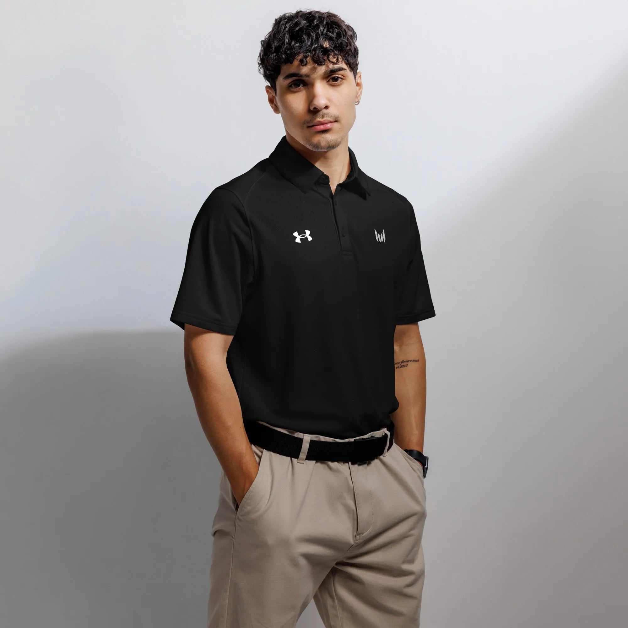 Under Armour men's black polo shirt worn by male model front-facing