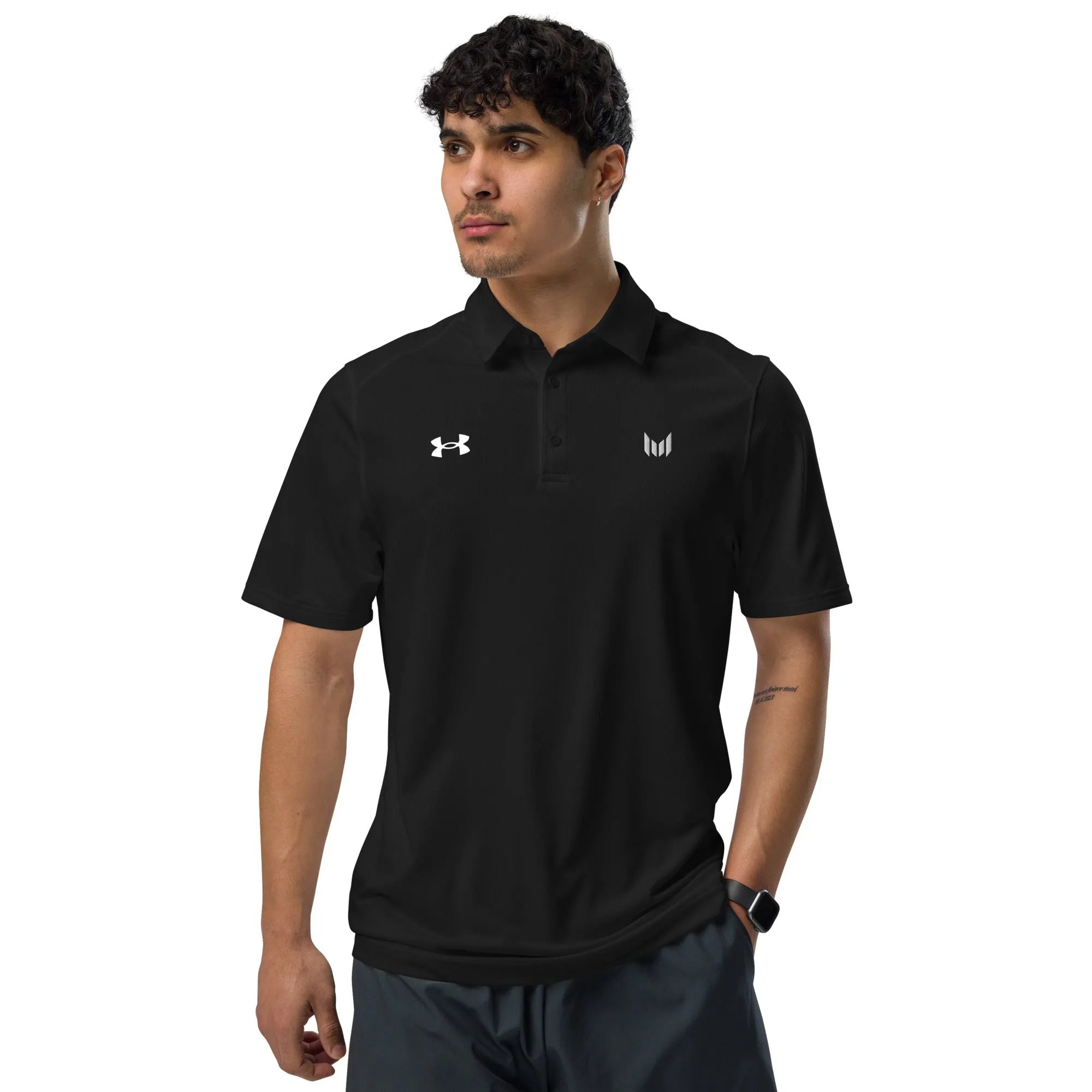 Under Armour black polo styled in motion by male model with hands at side