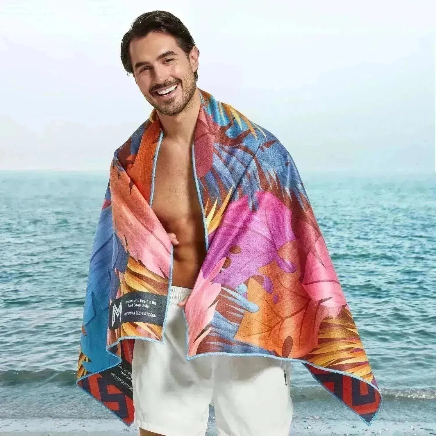 Model with towel draped from shoulders showing full gradient leaf print design
